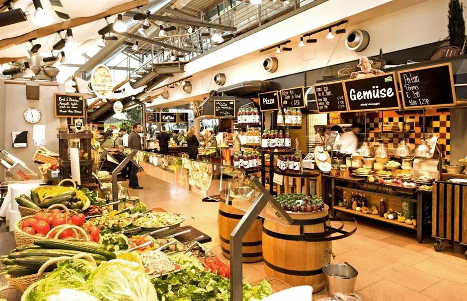 Busy food hall with fresh produce displays and service counters