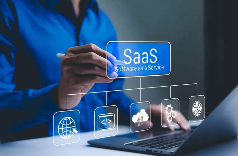 Person working at a laptop with a SaaS platform concept diagram