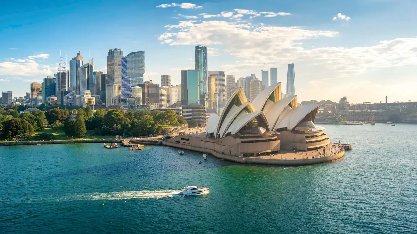 Sydney Opera House on the harbour, with the city skyline behind it